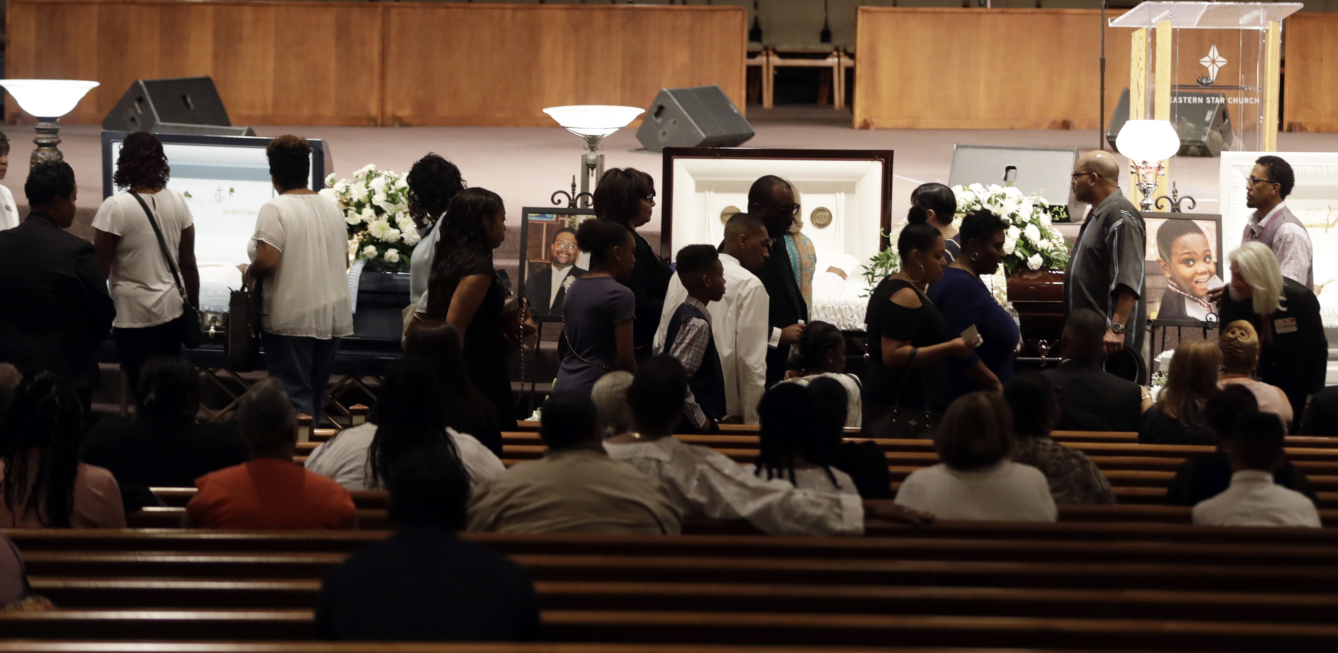 The Latest: 100s at funeral for 5 relatives killed in boat