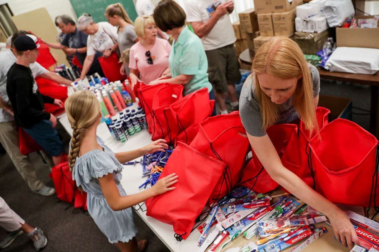 Lacy Gill, bottom right, and others assemble personal hygiene kits, including items such as toothpaste, shampoo and bodywash, to be distributed to homeless during a service project at an LDS meetinghouse in Millcreek on Saturday, July 28, 2018. Members of the Canyon Rim neighborhood of Millcreek gathered for three days of service projects. (Photo: Spenser Heaps, KSL)