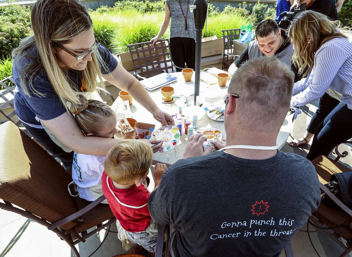 Chad Jaggi, left, his children Bella and Braden and wife Stephanie attend a sunflower planting party in honor of Sarcoma Awareness Month at the Huntsman Cancer Institute in Salt Lake City on Monday, July 30, 2018. Jaggi has angiosarcoma, a rare type of cancer that forms in the lining of the blood vessels. (Photo: Steve Griffin, KSL)