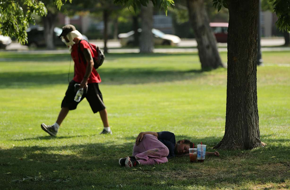 Homeless people rest and walk in Pioneer Park in Salt Lake City on Wednesday, Aug. 1, 2018. The city will install a large lawn in the south-central portion of the park that will include a surrounding walkway, sports field and sports lighting. The construction will allow for events such as evening soccer leagues and concerts in the park. The Pioneer Park Coalition is contributing $300,000 toward construction. (Photo: Jeffrey D. Allred, KSL)