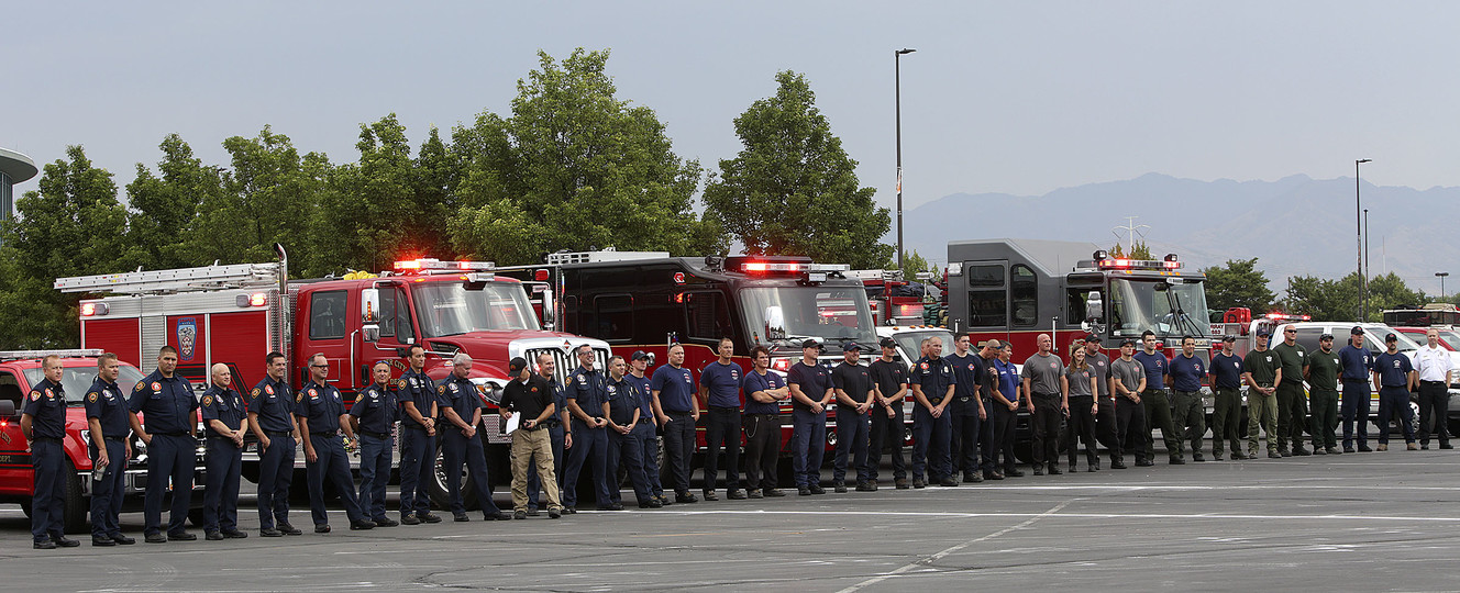 Firefighters from Salt Lake City, Draper, Murray, Lone Peak, Provo, Uintah City (Weber County) and West Valley City outside the Maverik Center in West Valley City before they deploy to California to help fight the wildfires there on Thursday, Aug. 2, 2018. (Photo: Kristin Murphy, KSL)