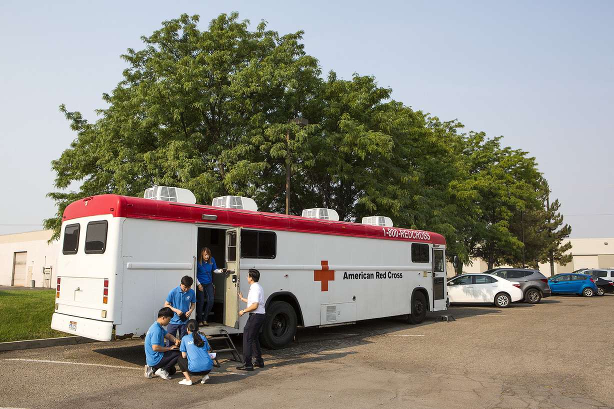 People come and go from an American Red Cross bus in the parking lot of the World Mission Society Church of God in Salt Lake City on Sunday, Aug. 5, 2018. The church hosted a blood drive to combat a blood shortage in Utah hospitals. (Photo: James Wooldridge, KSL)