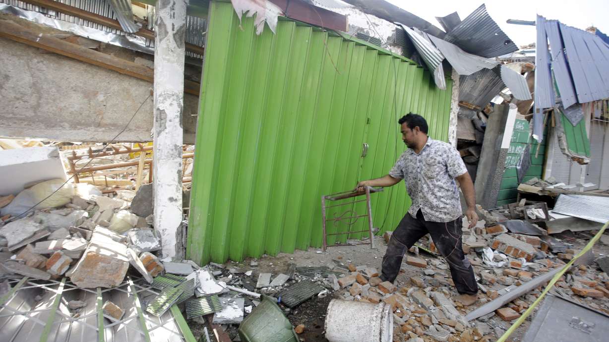 AP Photos: Rescuers search for missing on Indonesian island