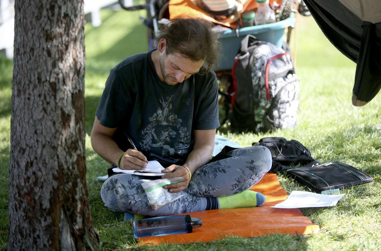 Pi Mike, who says he is home-free, writes at Library Square in Salt Lake City on Wednesday, Aug. 8, 2018. (Photo: Kristin Murphy, KSL)