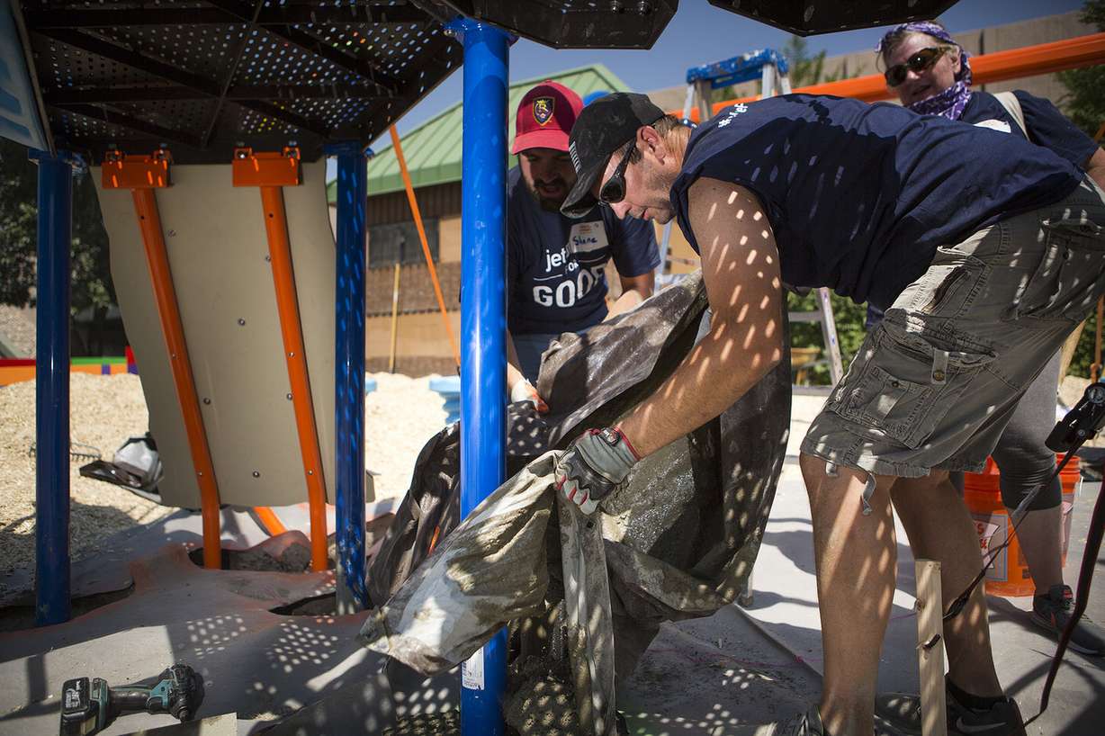 Jason Rowley and other volunteers build a new playground in South Salt Lake on Thursday, Aug. 9, 2018. The playground was based on drawings made by children in the community in June. (Photo: James Wooldridge, KSL)