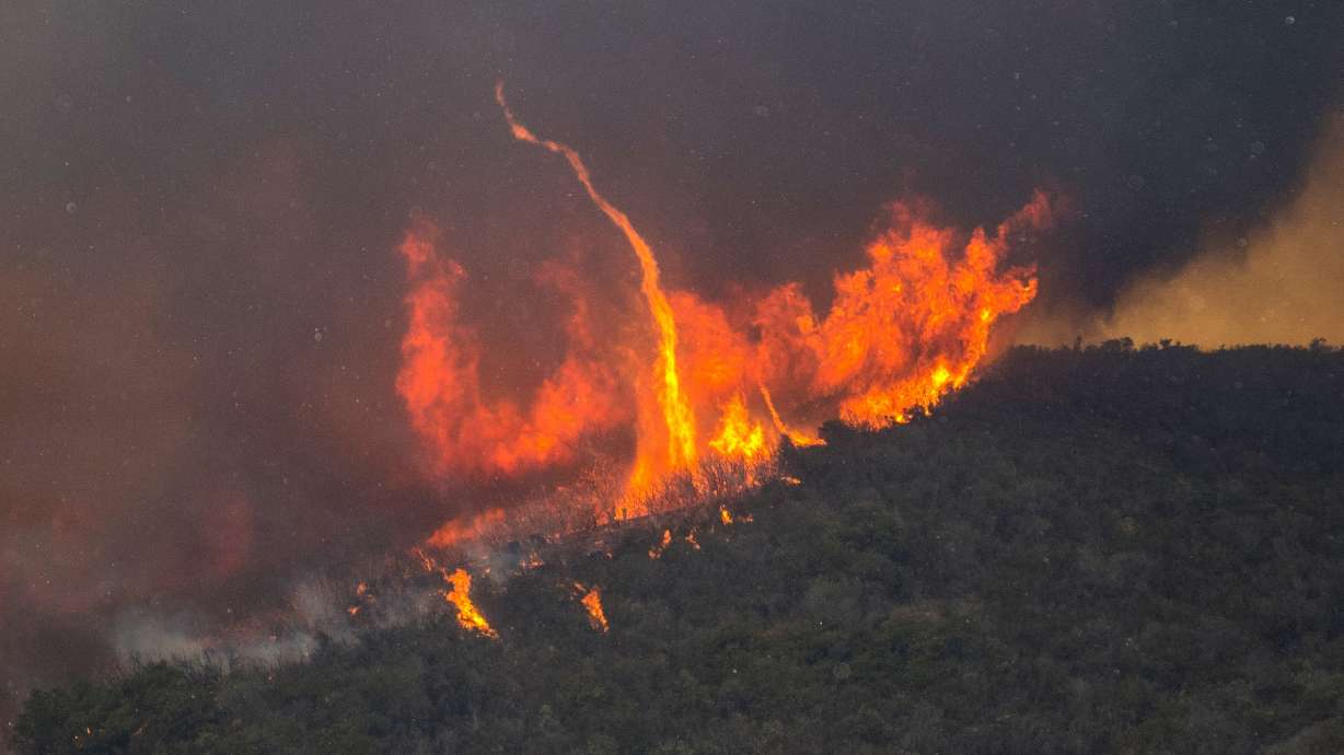 Flames inch close to California homes as thousands evacuate