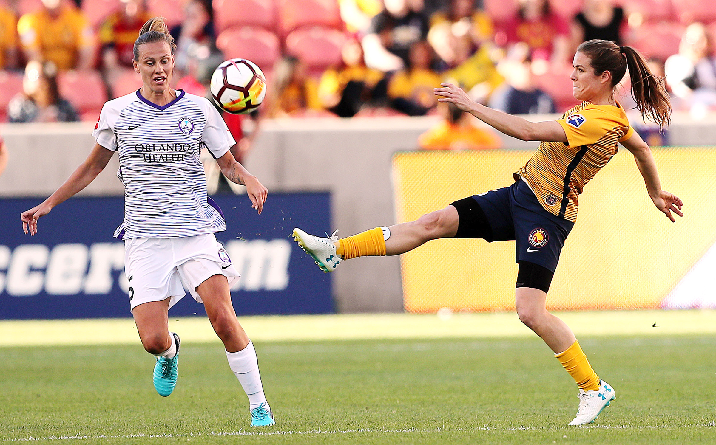 Orlando City midfielder Emily van Egmond (5) Utah Royals FC defender Kelley O'Hara (5) try to chase dow the ball as the Utah Royals and the Orlando Pride play at Rio Tinto Stadium in Sandy on Wednesday, May 9, 2018. (Photo: Scott G Winterton, Deseret News)