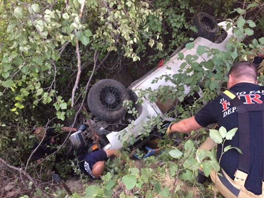 Emergency responders work to free Joe Rightmire, 21, who was pinned underneath a pickup truck in the mountains southeast of Idaho Falls, Idaho. Rightmire had been missing for several days and was in stable condition when he was found on Monday, Aug. 6, 2018. (Photo: Idaho Falls Fire Department)