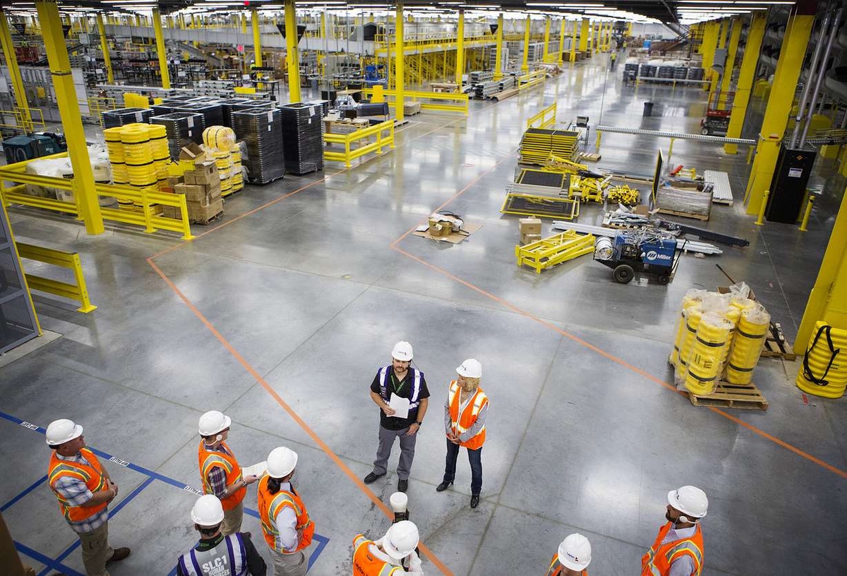 Michael Taylor, general manager of Amazon's new Utah fulfillment center, and Salt Lake City Mayor Jackie Biskupski stand before members of the media during a tour of the new facility in Salt Lake City on Monday, Aug. 13, 2018. The 855,000-square-foot facility will employ over 1,500 full-time workers, shipping smaller items to customers. (Photo: James Wooldridge, KSL)