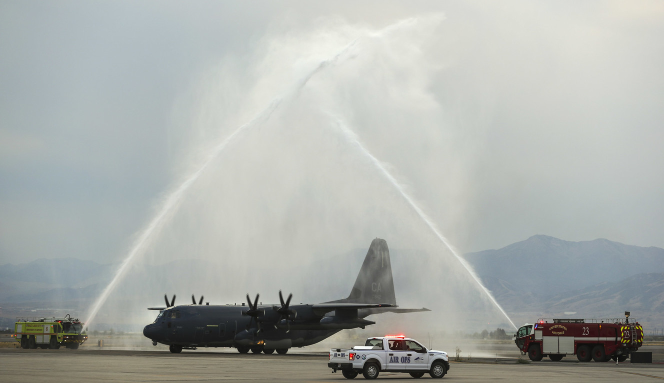 A C130-J carrying the casket of Draper Battalion Chief Matt Burchett taxis through a water arch as it lands at the Utah Air National Guard Base in Salt Lake City on Wednesday, Aug. 15, 2018. Burchett was killed while fighting the Mendocino Complex Fire north of San Francisco. (Photo: Steve Griffin, KSL)