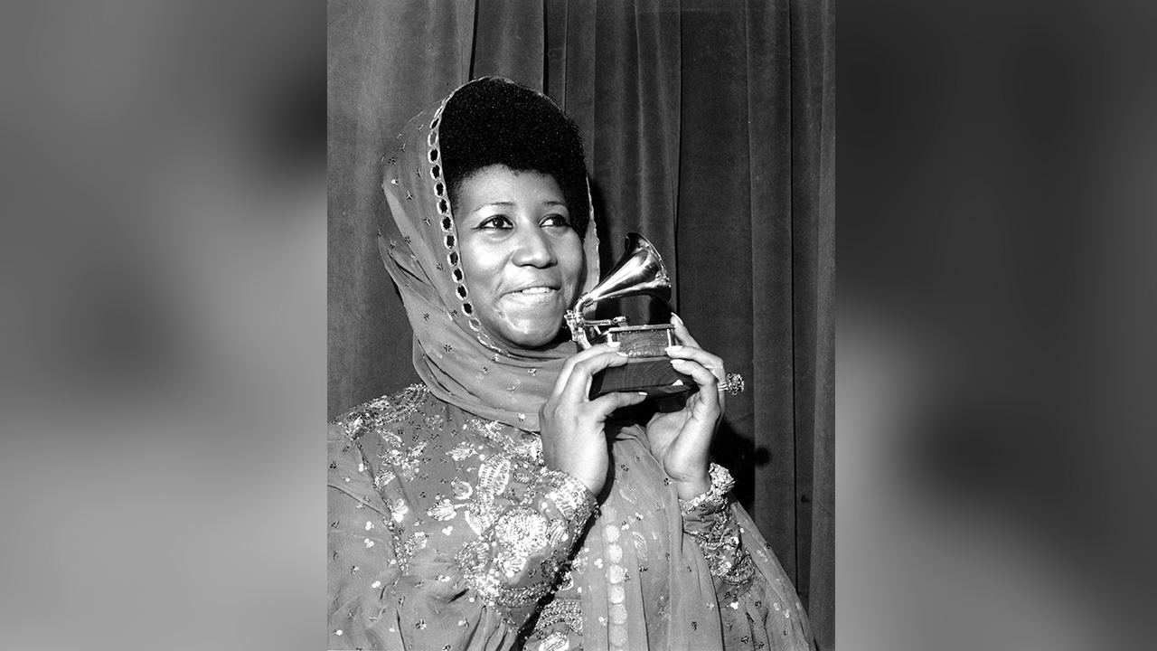 In this March 3, 1975 file photo, singer Aretha Franklin poses with her Grammy Award for for best female R&B vocal performance for "Ain't Nothing Like the Real Thing" at the 17th Annual Grammy Award presentation in New York. Franklin died Thursday, Aug. 16, 2018 at her home in Detroit. She was 76. (AP Photo, File)