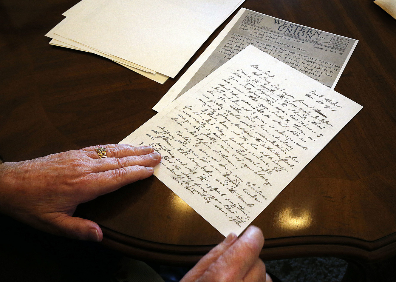 Robert J. Holmes, nephew to Marine Corps Pfc. Robert K. Holmes, shows a copy of a letter in Draper on Thursday, Aug. 16, 2018, written by Pfc. Holmes from Pearl Harbor days before the Japanese attacked. Pfc. Holmes, 19, of Salt Lake City, was killed during the attack. Behind the letter is a copy of the telegram reporting Pfc. Holmes as missing. (Photo: Ravell Call, KSL)
