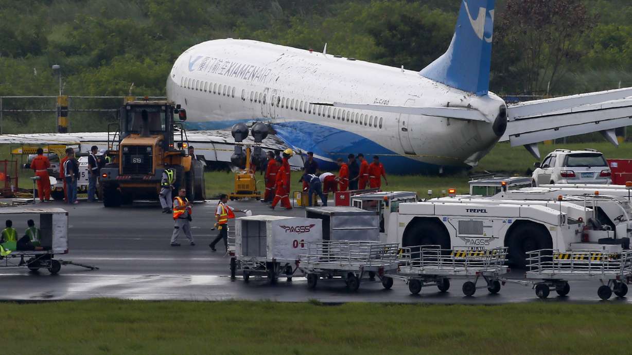 Plane skids off rainy Manila runway, rips off engine, wheel
