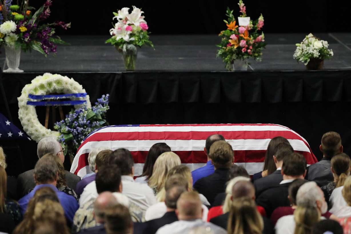 Attendees are seated nears the casket during funeral services for Code Enforcement Officer Jill Robinson at the Maverik Center in West Valley City on Friday, Aug. 17, 2018. (Photo: Jeffrey D. Allred, KSL)