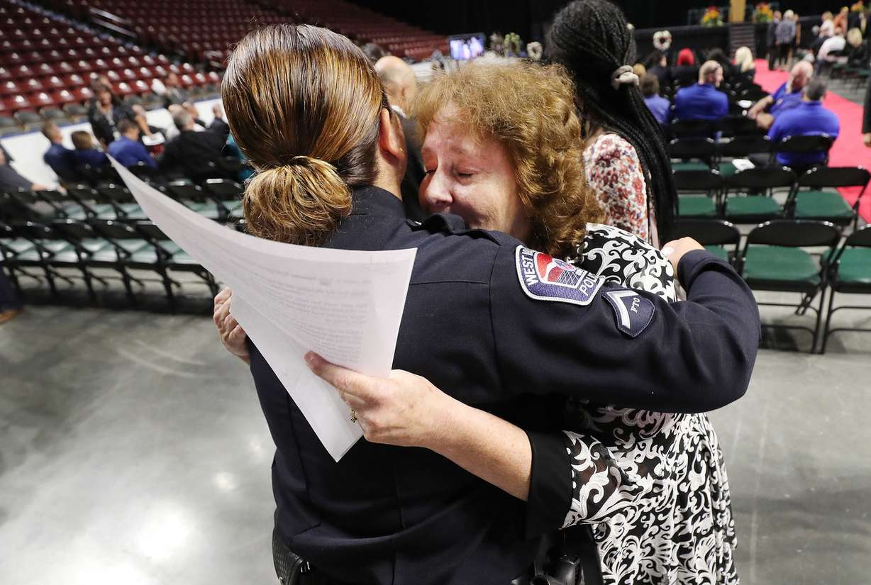 Julie Robinson Egelund, sister of Code Enforcement Officer Jill Robinson, hugs an officer prior to funeral services at the Maverik Center in West Valley City on Friday, Aug. 17, 2018. (Photo: Jeffrey D. Allred, KSL)