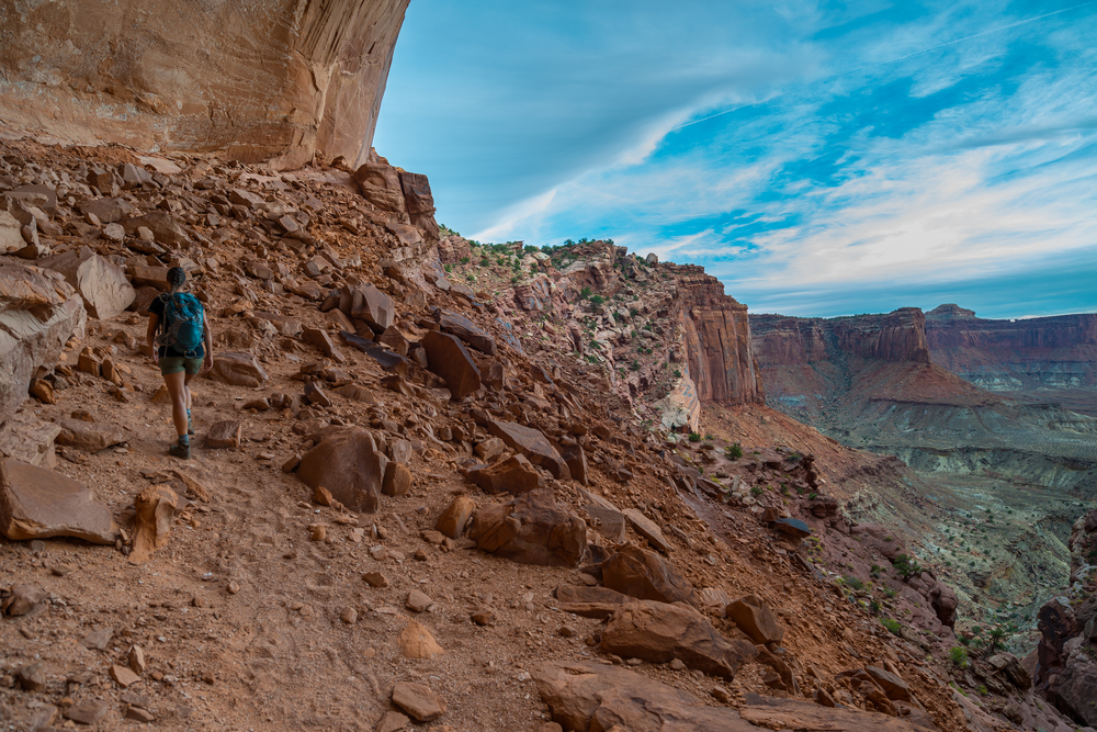 A backpacker hiking False Kiva Trail at Canyonlands National Park. The trail remains open to hikers, but the False Kiva alcove was closed July 20 after a vandalism incident. (Photo: Kris Wiktor, Shutterstock)