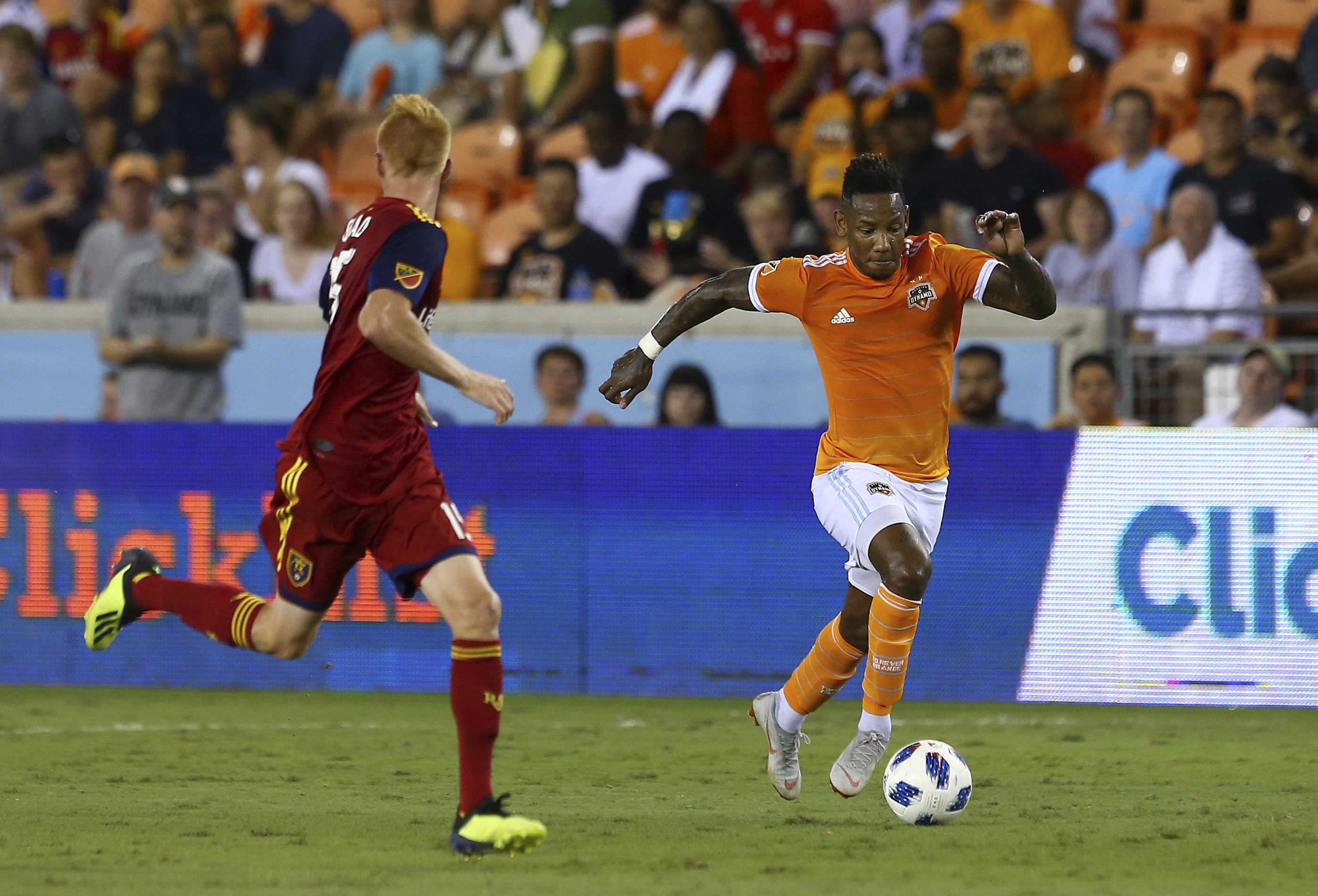 Houston Dynamo forward Romell Quioto, right, dribbles the ball upfield against Real Salt Lake defender Justen Glad (15) during the first half of an MLS soccer game Saturday, Aug. 18, 2018, in Houston. (Godofredo A. Vasquez/Houston Chronicle via AP)