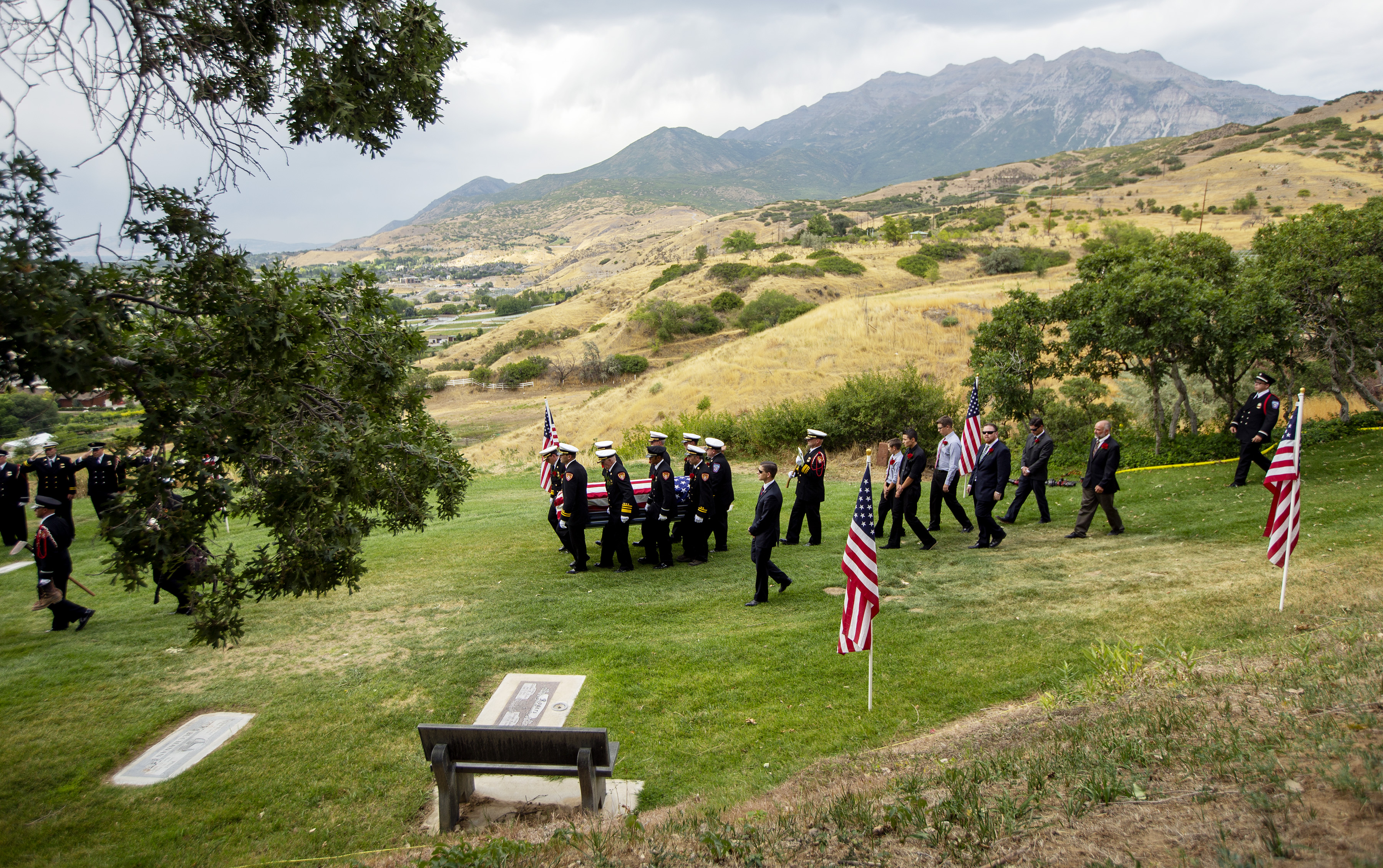 Draper firefighters carry the casket of Draper Battalion Chief Matthew Burchett to the grave site at East Lawn Memorial Hills cemetery in Provo for graveside services on Monday, Aug. 20, 2018.