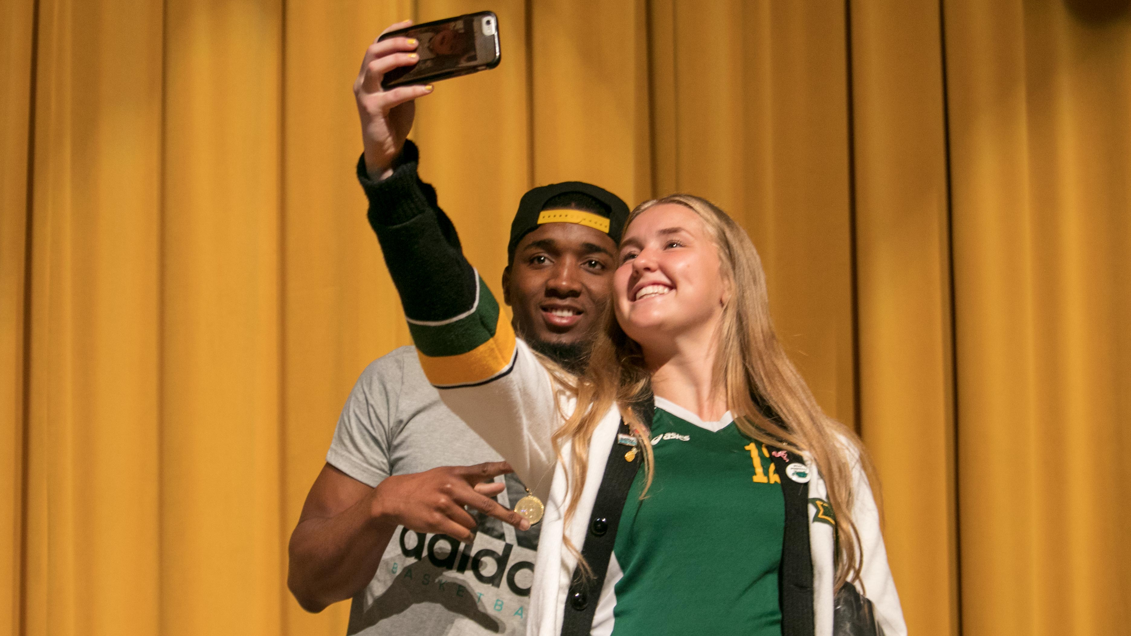 A student takes a selfie with Donovan Mitchell at Kearns High School on Aug. 21, 2018. (Photo: Josh Furlong, KSL.com)