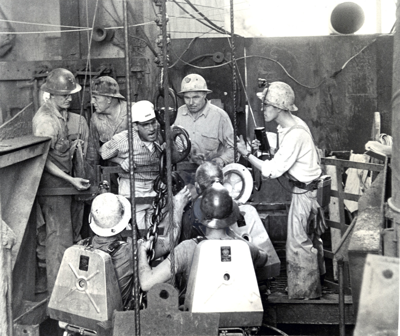 An Aug. 29, 1963 file photo shows rescuers surrounding a bucket used to bring survivors of a potash mine explosion near Moab to the surface. The explosion on Aug. 27, 1963, killed 18 miners and trapped others for more than two days in almost intolerable conditions. (Photo: David E. Jirovec, Deseret News)