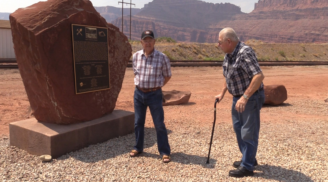 Survivors Charles Clark and Paul McKinney stand near a memorial on Tuesday, Aug. 14, 2018, that honors the 18 miners who died in an explosion in 1963, in Potash, Utah. Clark and McKinney were among the seven people who survived the explosion. McKinney and another miner were brought to the surface 13 hours after the blast. More than two full days after the blast, rescuers reached the five remaining miners, including Clark, and brought them to the surface. (Photo: John Hollenhorst, KSL TV)