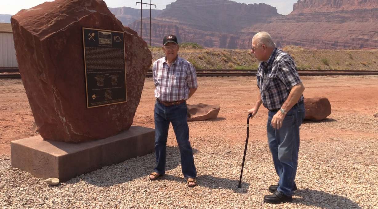 Survivors Charles Clark and Paul McKinney stand near a memorial on Tuesday, Aug. 14, 2018, that honors the 18 miners who died in an explosion in 1963, in Potash, Utah. Clark and McKinney were among the seven people who survived the explosion. McKinney and another miner were brought to the surface 13 hours after the blast. More than two full days after the blast, rescuers reached the five remaining miners, including Clark, and brought them to the surface. (Photo: John Hollenhorst, KSL TV)