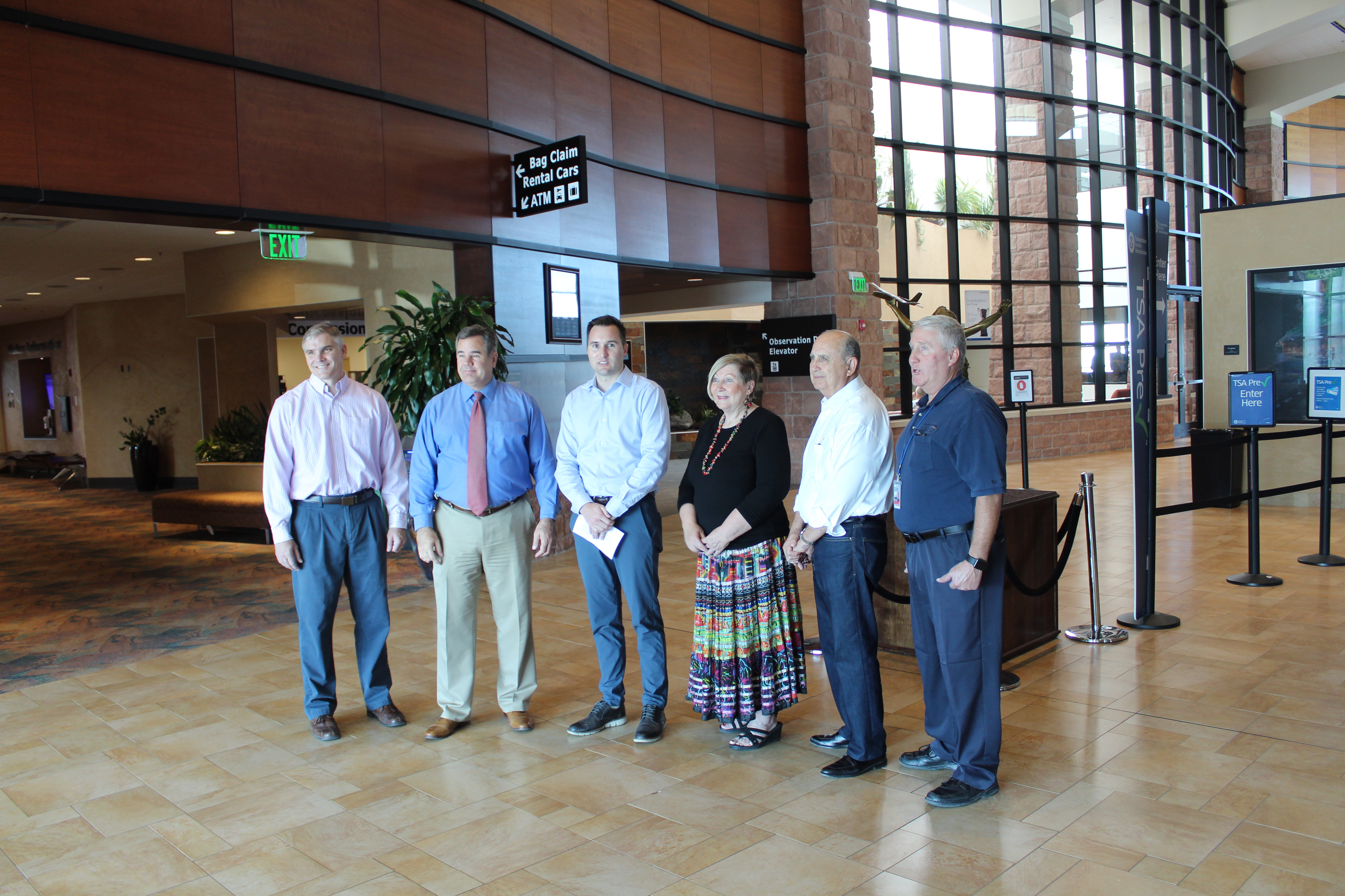L-R: St. George Public Works Director Cameron Cutler, Mayor Jon Pike, Allegiant Manager of Airport Affairs Dustin Call, Councilwoman Bette Arial, Councilman Ed Baca and St. George Regional Airport Manager Richard Stehmeier announce a new flight route to Mesa, St. George, Utah, Aug. 21, 2018 (Photo by Mikayla Shoup, St. George News.)