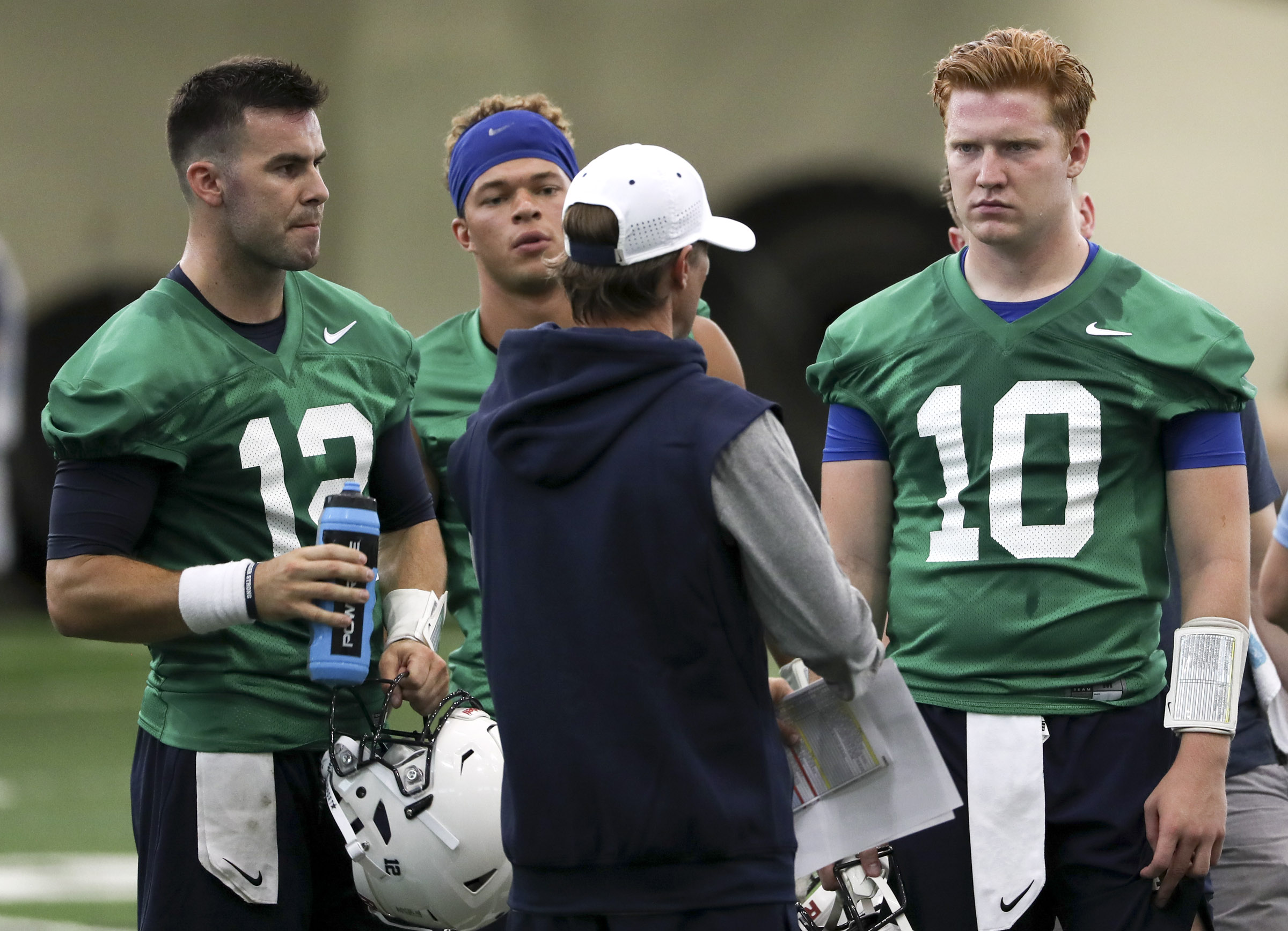 BYU quarterbacks Tanner Mangum, left, Jaren Hall and Joe Critchlow, right, talk with quarterbacks coach Aaron Roderick after football practice in Provo on Friday, Aug. 3, 2018. (Photo: Steve Griffin, Deseret News)