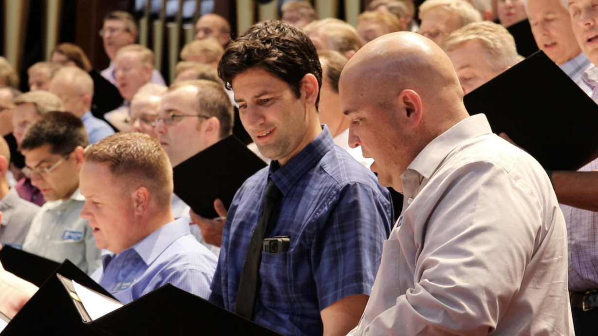 Daniel Seddiqui gets help from his neighbor while practicing with the Mormon Tabernacle Choir Thursday. (Photo: Liesl Nielsen, KSL.com)