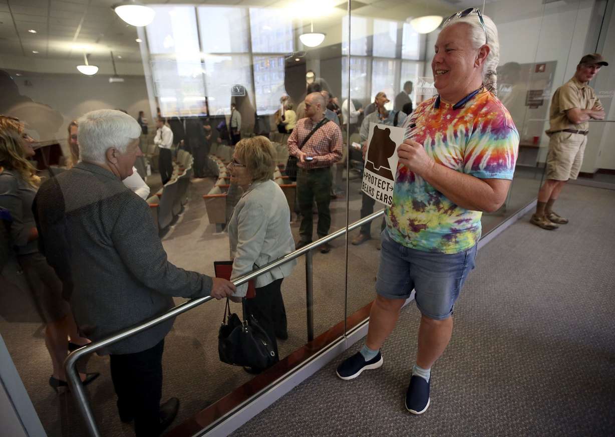 Pam Harrison tries to get the attention of Rep. Rob Bishop with a Protect Bears Ears sign after a roundtable discussion at the Ogden-Weber Chamber of Commerce in Ogden, Utah, on Tuesday, Aug. 28, 2018. (Kristin Murphy/The Deseret News via AP)