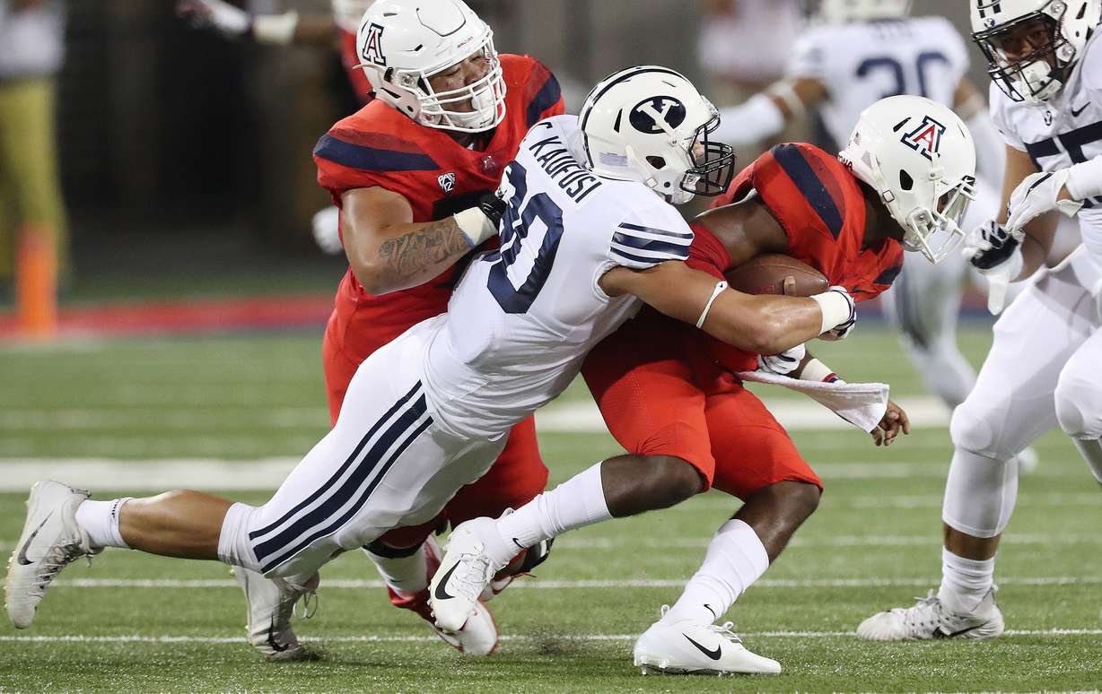 Brigham Young Cougars defensive lineman Corbin Kaufusi (90) sacks Arizona Wildcats quarterback Khalil Tate (14) against the Arizona Wildcats in Tucson on Saturday, Sept. 1, 2018. (Photo: Jeffrey D. Allred, Deseret News)