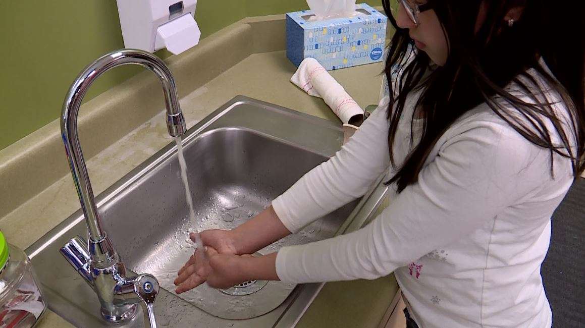 A student washes her hands after learning the proper technique from her school nurse, Kim Lowe. (Photo: KSL TV)