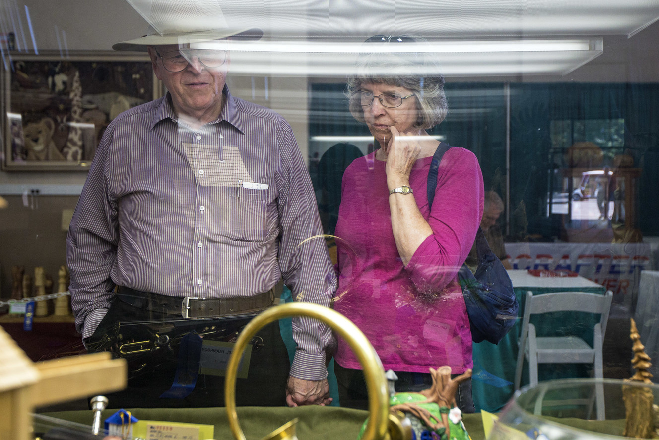 Roy Luker and his wife, Ellen, look at artifacts on display during the opening day of the Utah State Fair at the Utah State Fairpark in Salt Lake City on Thursday, Sept. 6, 2018. The Lukers have been coming to the state fair for more than four decades. (Photo: Qiling Wang, KSL)