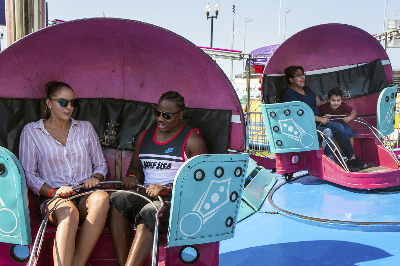 Ashlee Race, left, Jerome Parker, Nelly Flores and Damian Flores settle in a ride during the opening day of the Utah State Fair at the Utah State Fairpark in Salt Lake City on Thursday, Sept. 6, 2018. (Photo: Qiling Wang, KSL)