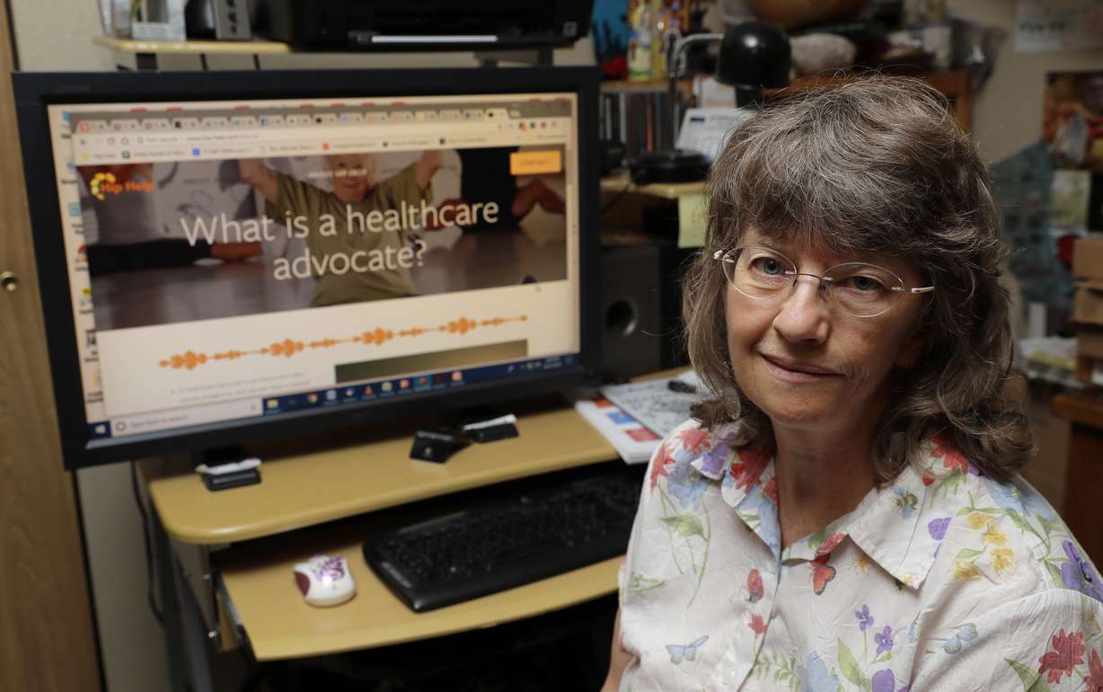 In this Aug. 22, 2018 photo, April Box poses for a photo at her home in Spokane, Wash. Box is a healthcare advocate and runs the website www.hip-help.com to help guide people through major surgeries and other aspects of the healthcare system. Millions of people covered under the Affordable Care Act will see only modest premium increases next year, and some will get a price cut. That’s the conclusion from an exclusive analysis of the besieged but resilient program that still divides voters heading into this year's midterm elections. (AP Photo/Ted S. Warren)