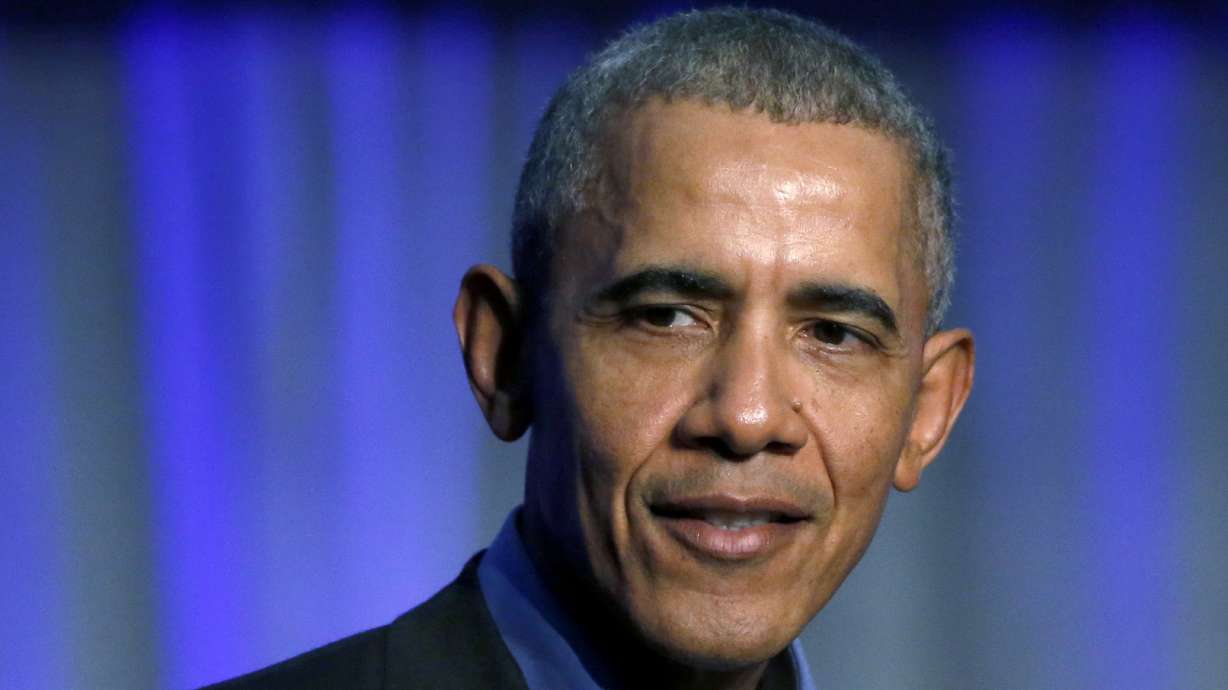 The Latest: Obama scorches Trump in return to campaign trail