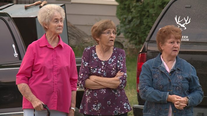 Elaine Goodey, right, watches with fellow Daughters of Utah Pioneers members as the tithing granary is hauled through Clarkston on Saturday, Sept. 8, 2018. (Photo: KSL TV)