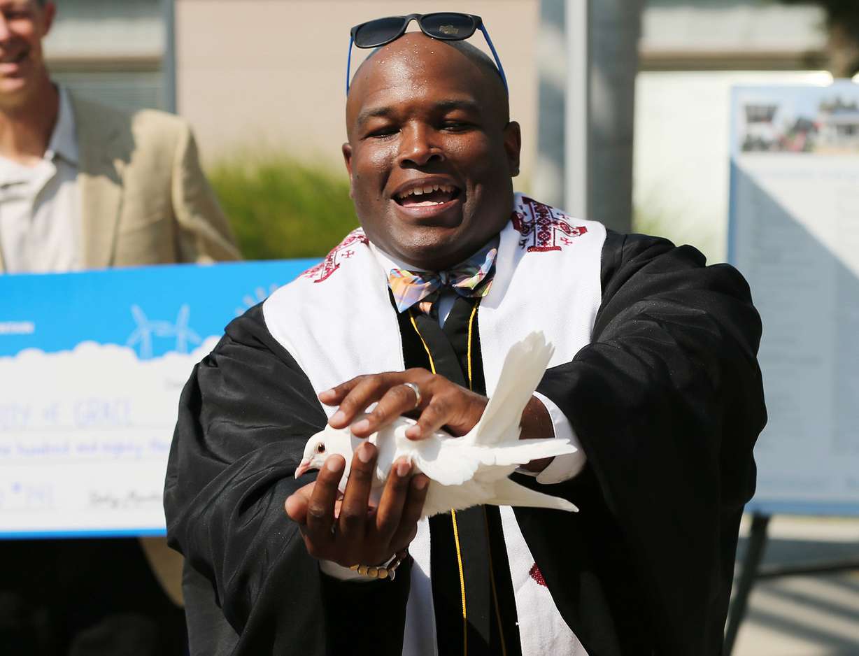 The Rev. Jerrod Lowry holds a dove during a celebration marking the completion of a completion of a 114-panel solar array project at Community of Grace Presbyterian Church in Sandy on Sunday, Sept. 9, 2018. (Photo: Jeffrey D. Allred, KSL)