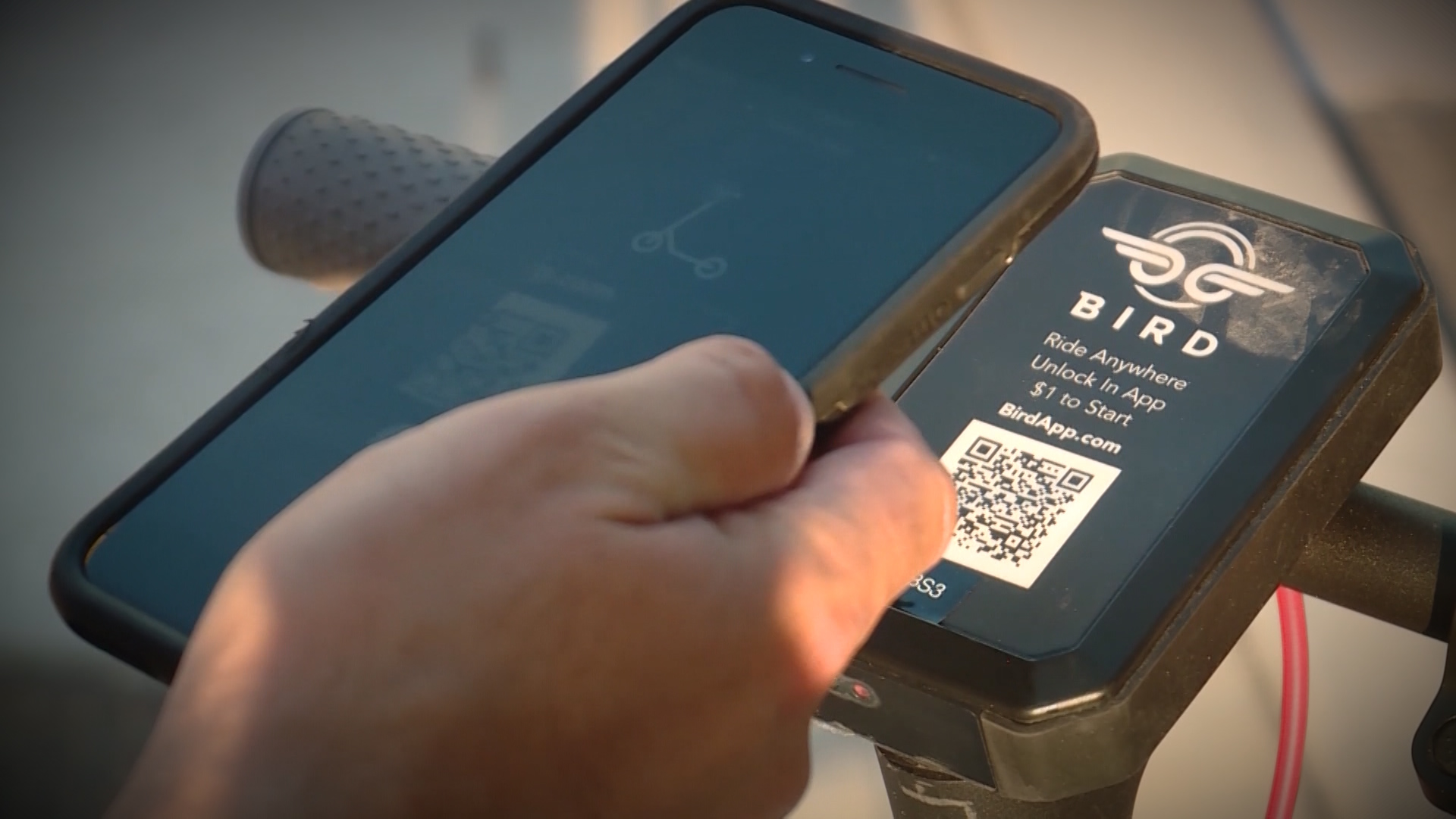 A Bird rider scans a QR code to start a ride. Photo: KSL TV
