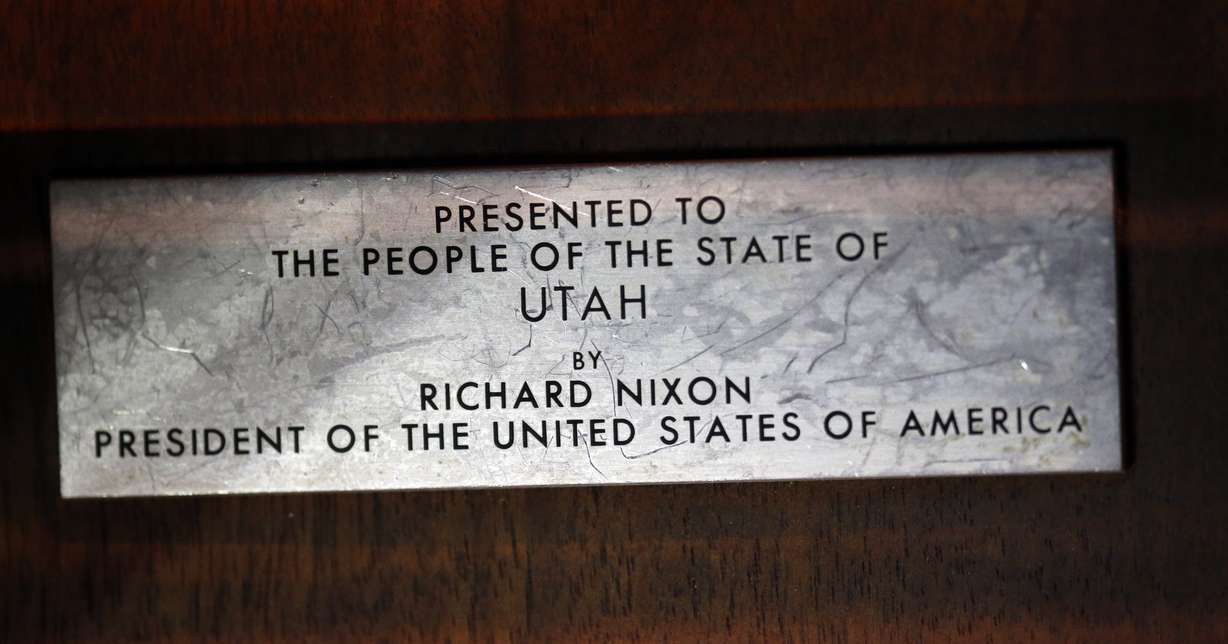 This Wednesday, Aug. 22, 2018, photo shows a plate mounted on a wooden plaque that holds moon rocks encased in acrylic at the Clark Planetarium, in Salt Lake City. (Rick Bowmer, AP Photo, File)