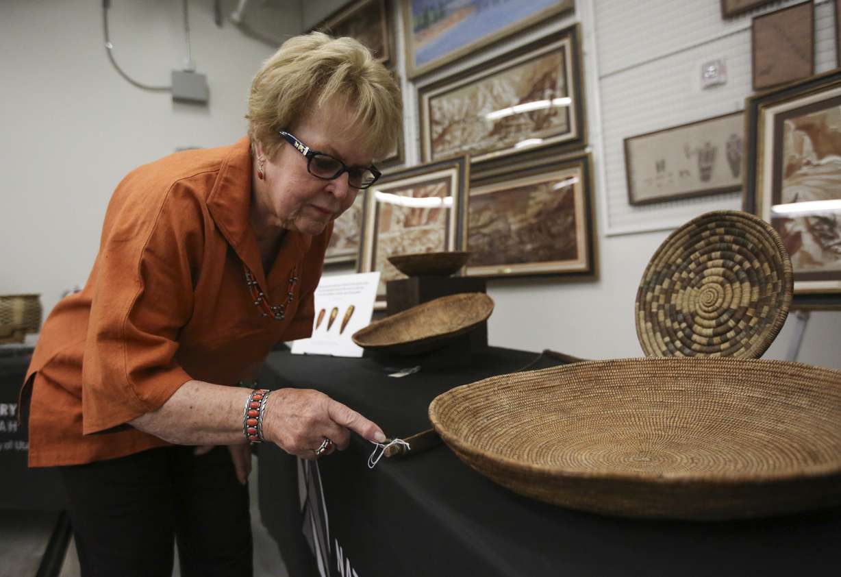 Anthropologist Catherine Fowler looks at the sinew string attached to a wooden bow, collected by explorer John Wesley Powell, at the Natural History Museum of Utah in Salt Lake City on Thursday, Sept. 13, 2018. Photo: Kristin Murphy, KSL