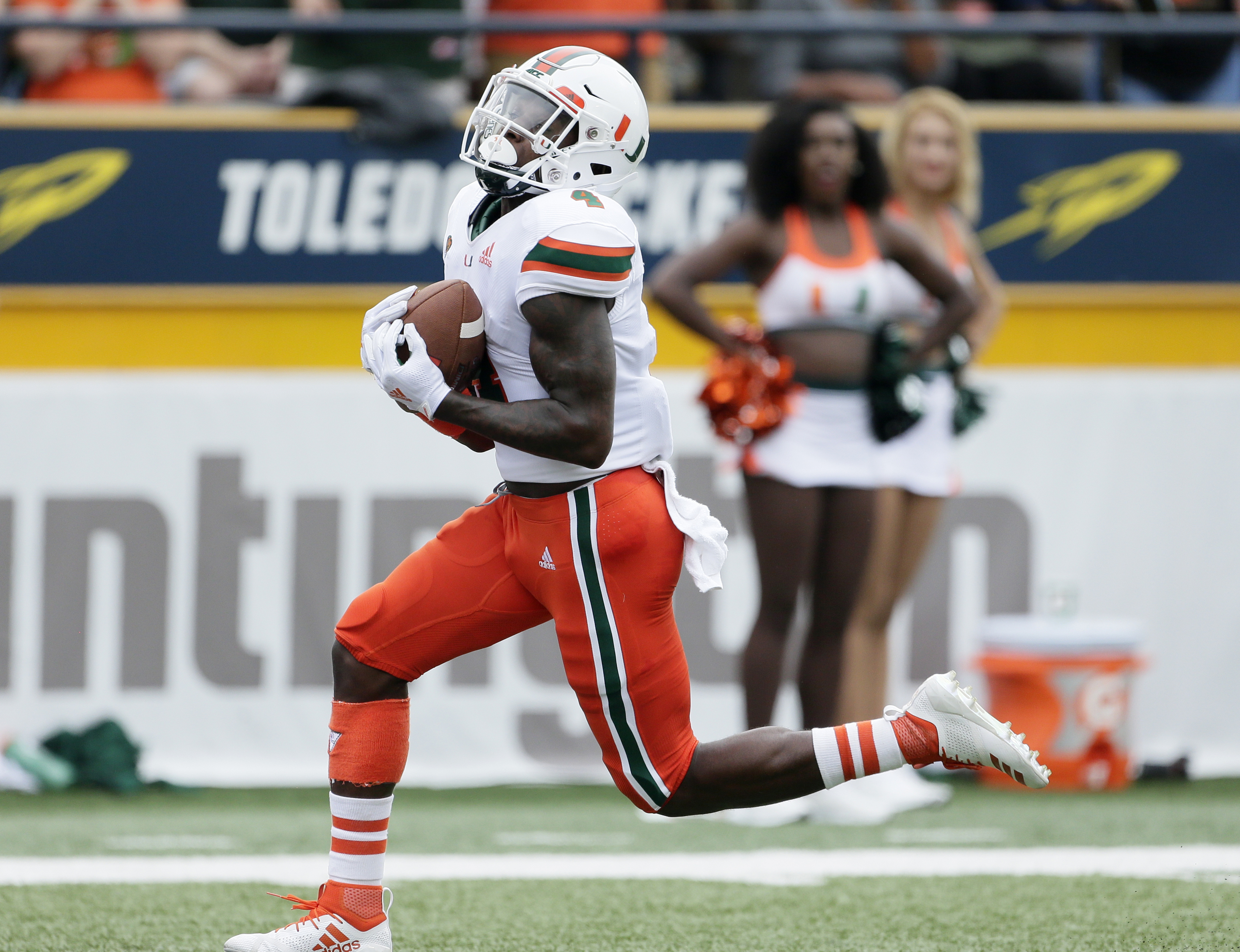 No. 21 Miami rolls past upset-minded Toledo 49-24