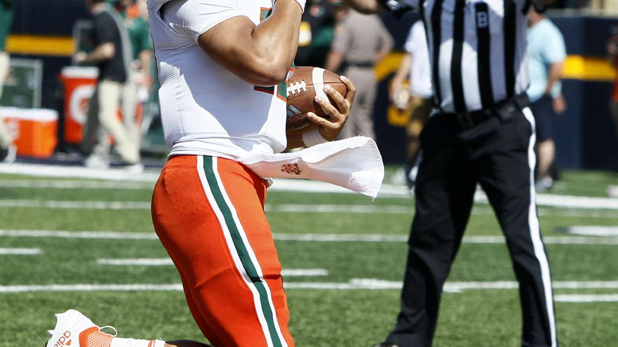 No. 21 Miami rolls past upset-minded Toledo 49-24