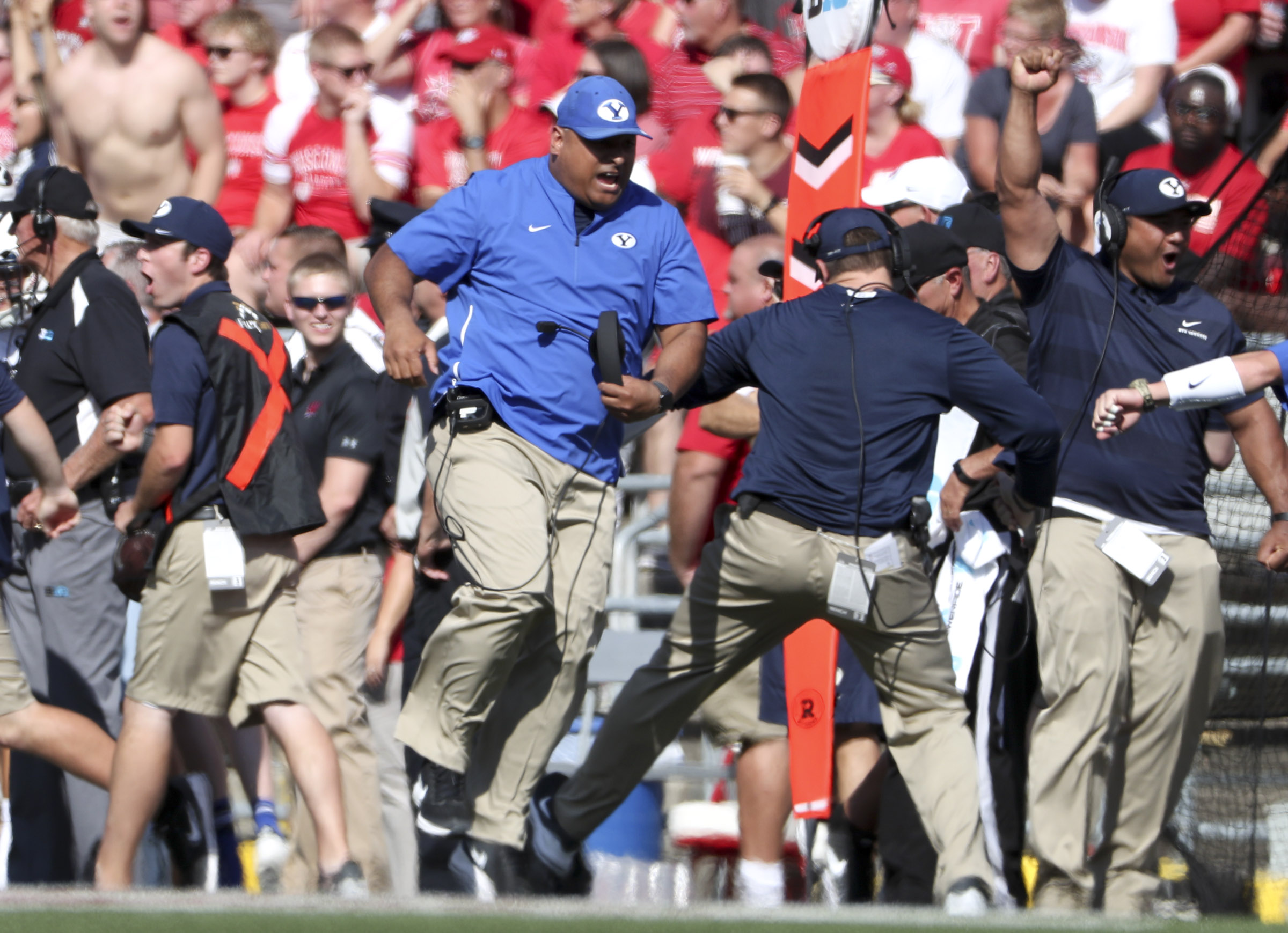 BYU coach Kalani Sitake and the BYU sideline explode with excitement after a half back pass goes for a touchdown during the Wisconsin versus BYU football game at Camp Randall Stadium in Madison, WI in Salt Lake City on Saturday, Sept. 15, 2018. (Photo: Steve Griffin, Deseret News)