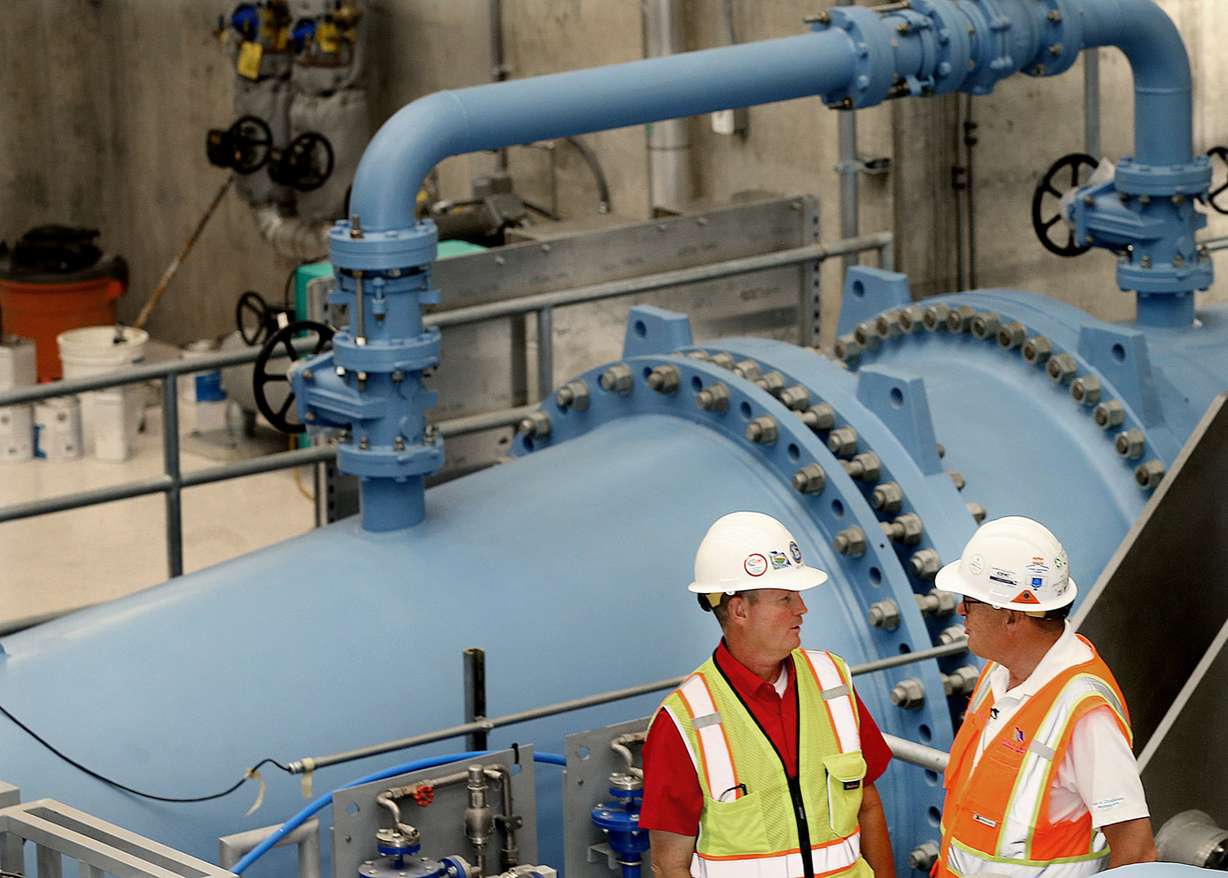 Richard Tullis, assistant general manager of the Central Utah Water Conservancy District, and K.C. Shaw, the district's chief engineer, stand next to a turbine at the new Olmsted Hydropower plant in Orem on Wednesday, Sept. 12, 2018. (Photo: Laura Seitz, KSL)