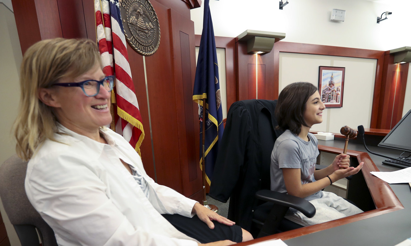With 3rd District Court Judge Kara L. Pettit offering support, Nibley Park School fifth-grader Zsa Zsa Valle sits on the bench as she plays the role of a judge during a mock trial in Pettit's courtroom at the Scott M. Matheson Courthouse in Salt Lake City on Monday, Sept. 17, 2018. The mock trial was part of Utah Courts’ Constitution Day celebration. (Photo: Steve Griffin, KSL)