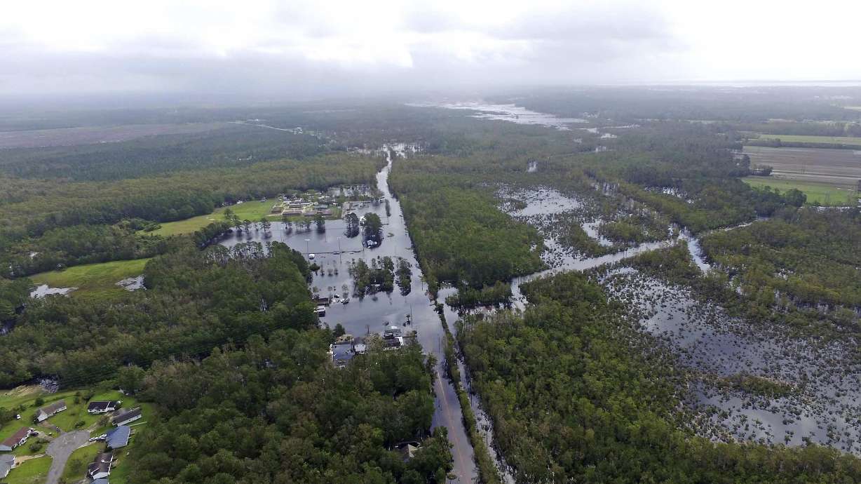 The Latest: 2 die in rising flood waters that overtook a van