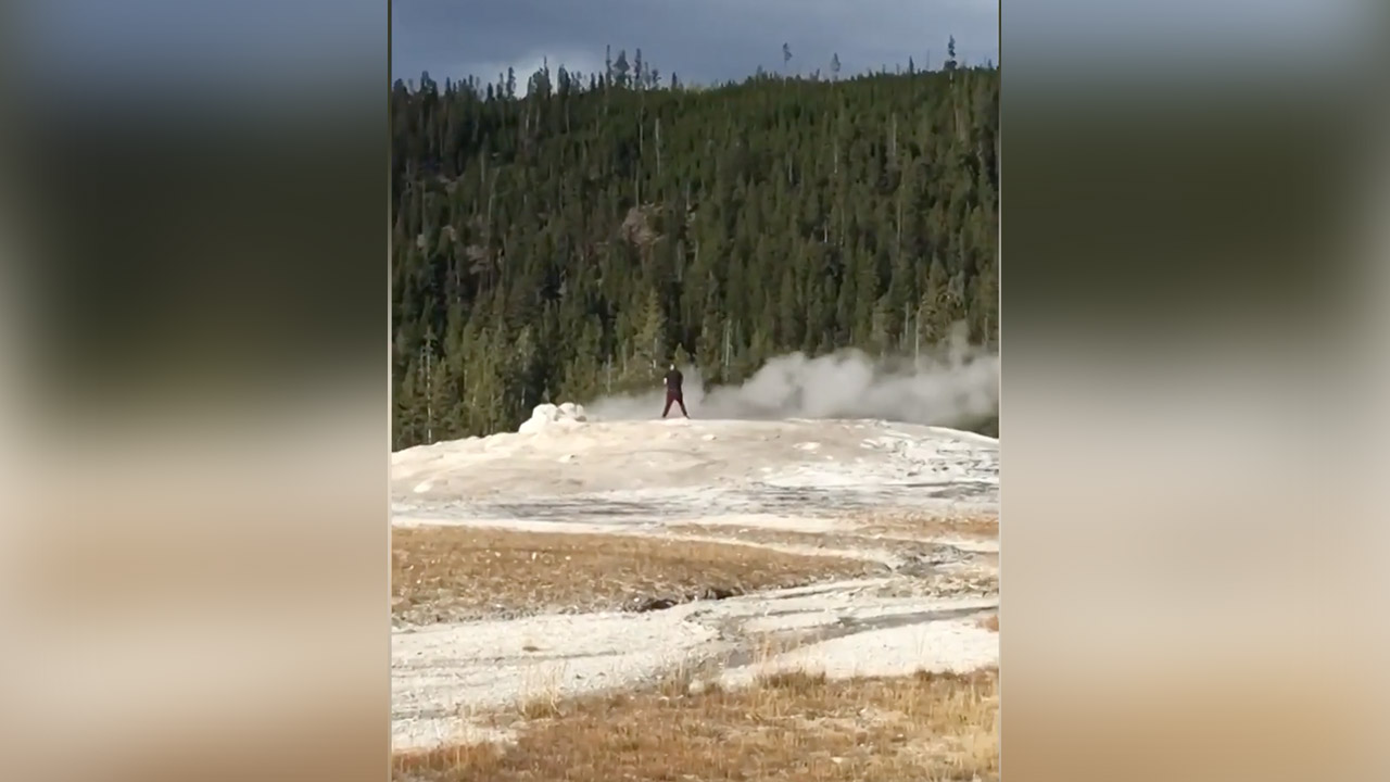 In a Sept. 14, 2018 video, a man appears to be urinating into Old Faithful. He then lays down next to the geyser.