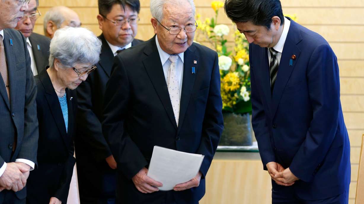 Japan's Abe re-elected as party head, to stay on as PM