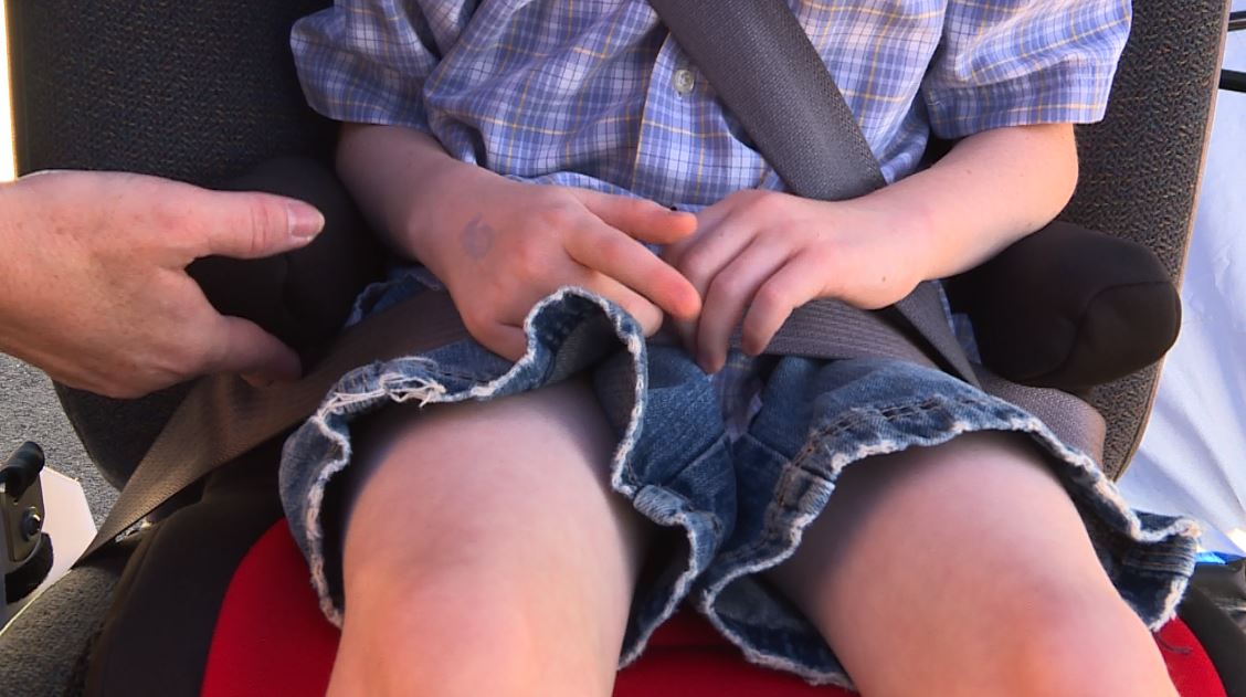 Keri Gibson encourages parents make sure the lap and shoulder belts are in the proper place on their child's booster seat. (Photo: KSL TV)